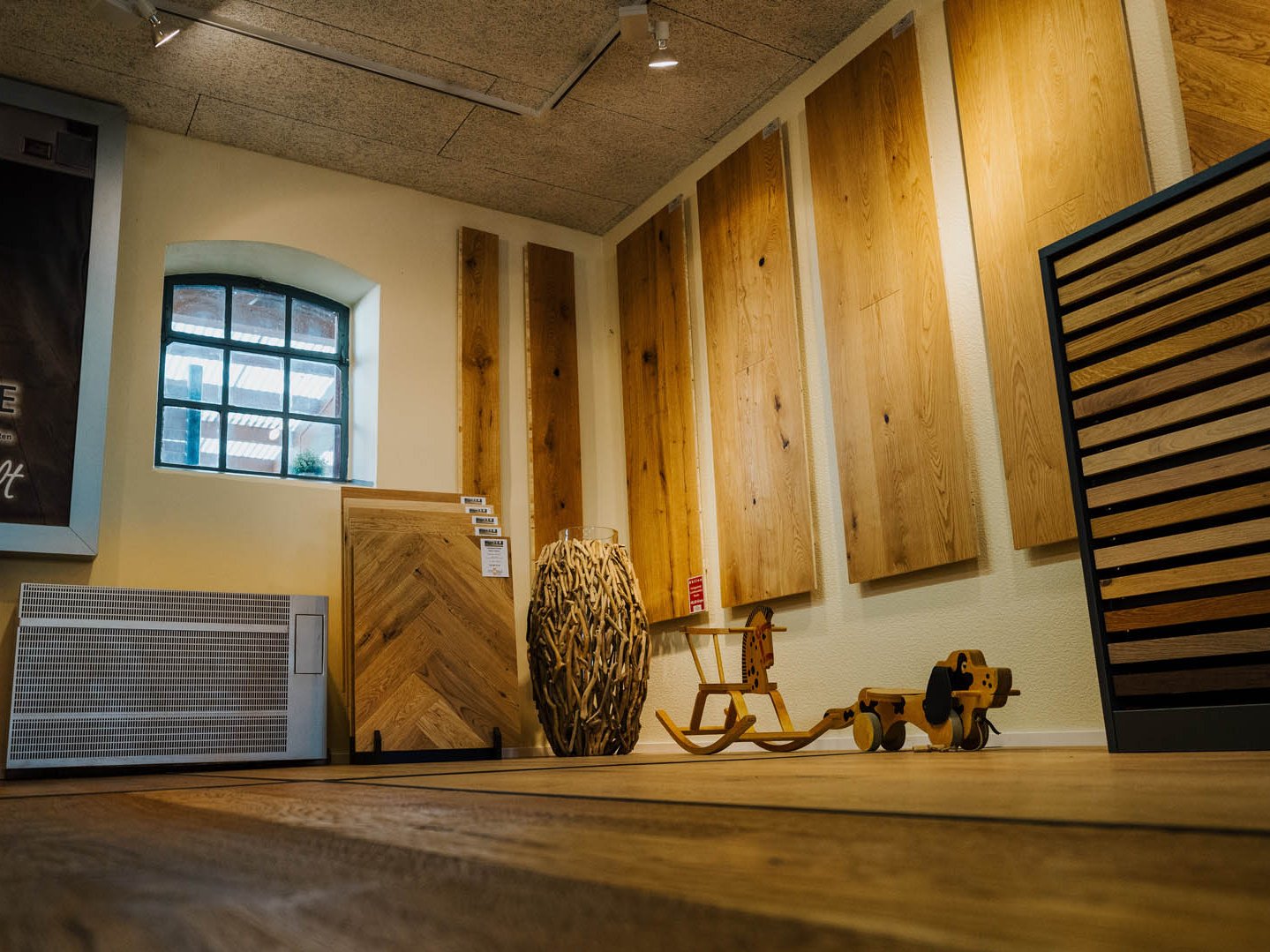 Ausstellungsraum für Parkett- und Holzfußböden mit Mustertafeln, Herringbone-Muster und Bodenpräsentation bei Holzhandlung Ströbele